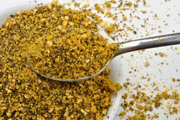 some organic lemon pepper in a white bowl