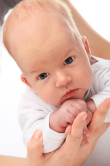 Little boy on mothers hands. Isolated on white background