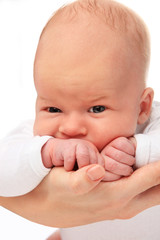 Little boy on mothers hands. Isolated on white background