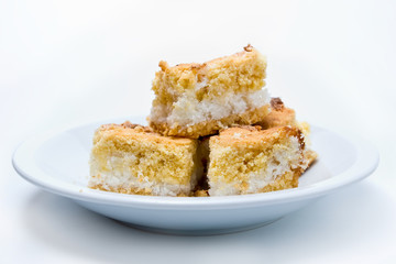 closeup of pieces of a cononut cake isolated on white