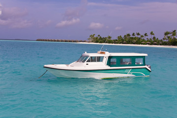 Fototapeta na wymiar Boat in ocean on background of tropical island