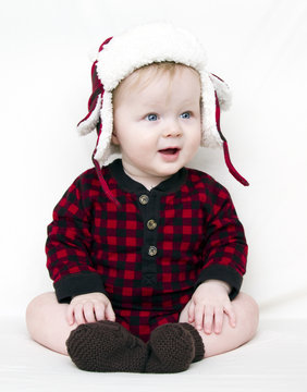 Christmas Baby With Red Plaid Shirt And Furry Wool Hat