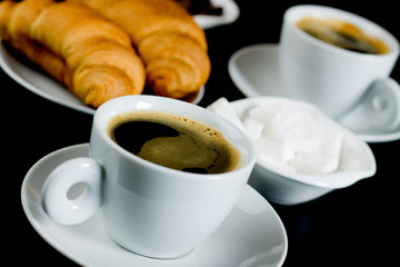 Cup of black coffee with croissants