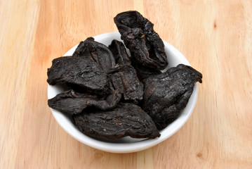 organic black tamarind in a white bowl