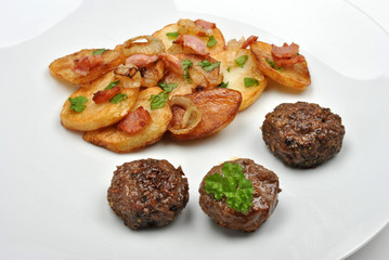 roasted potato with meat balls on a white plate