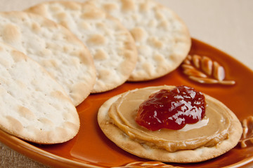 Sweet strawberry jelly and peanut butter on a cracker
