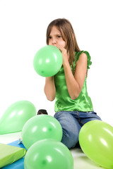Fototapeta na wymiar jeune adolescente qui gonfle un ballon vert