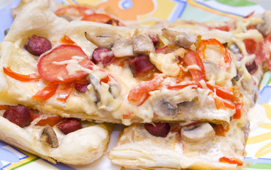 Pizza with mushrooms, red bell pepper, cheese and tomatoes.