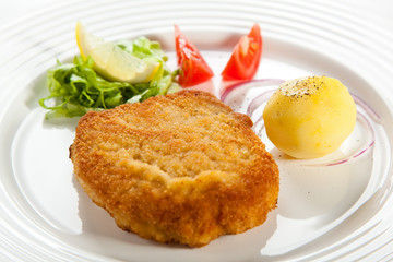Fried pork chop  with boiled potatoes and vegetables