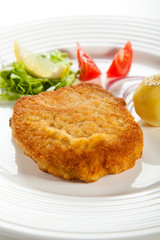 Fried pork chop  with boiled potatoes and vegetables