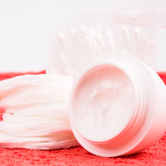 facial cream and cotton pads