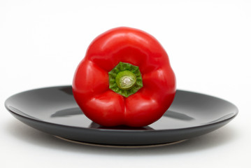 Red pepper on a black plate