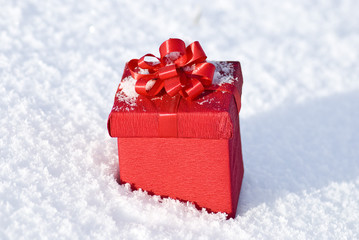 Red gift box on snow