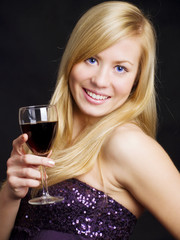 smiling beautiful woman holding wine and celebrating new year