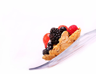 almond cake with berries on a transparent plate