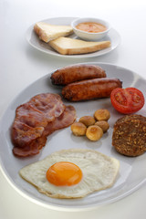 irish breakfast on a white plate with egg