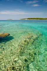Fototapeta na wymiar Mediterranean island with transparent green water and blue sky