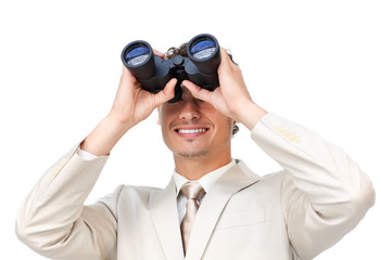 Businessman looking through binoculars