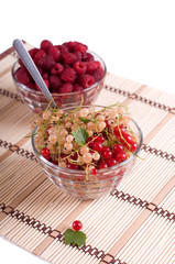 Fresh Raspberry and currant in cristal bowl isolated