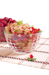 Fresh raspberry and currant in cristal bowl isolated