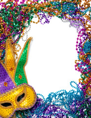 Border made of mardi gras bead and mask on white