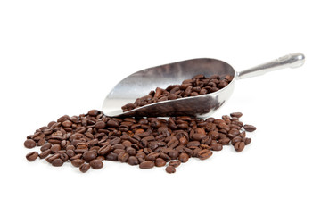 Coffee beans  and a  silver scoop on white