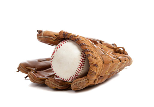 Baseball glove and ball on white