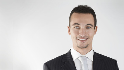 young businessman smiling with confidence