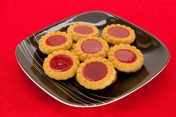 plate of cookies on red background