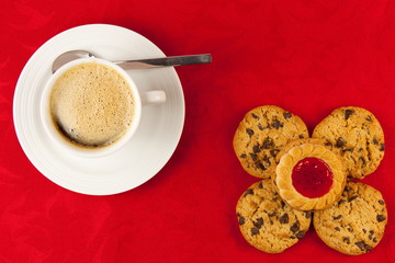 Coffee and cookies on a red background