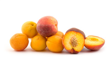 Ripe peaches and apricots isolated on a white background