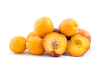 Ripe peaches and apricots isolated on a white background