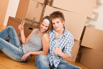 Fototapeta na wymiar Moving house: Happy man and woman celebrating