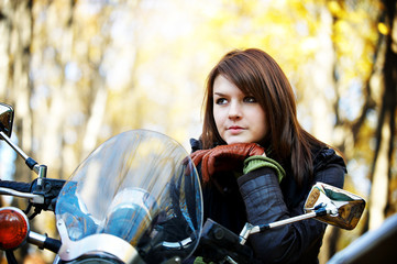 The girl the brunette on a motorcycle