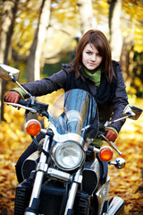 Fototapeta na wymiar The girl the brunette sits on a motorcycle