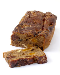 Loaf of brown bread with ingredients and slice