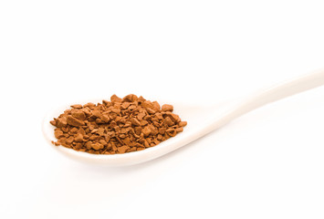 Full spoon of coffee on the white background