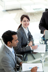 Businesswoman in a meeting smiling at the camera