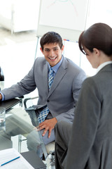 Young businessman sitting at a conference table