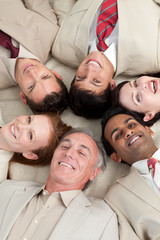 Fototapeta na wymiar Multi-ethnic business team lying in a circle