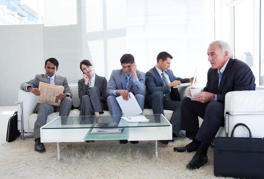 Business people sitting and waiting for a job interview