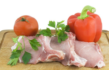 raw meat and sweet red paper at wooden background