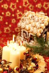 Fototapeta na wymiar Christmas decoration with candles and gingerbread house