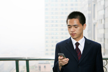 Fototapeta premium young asian businessman On the Balcony