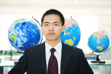 young asian businessman in the office with tellurion