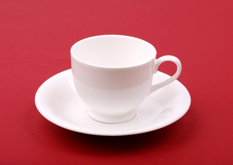 White porcelain cup on a red