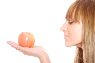 A pretty young woman holding an apple