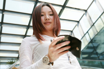 young asian businesswoman holding mobile phone