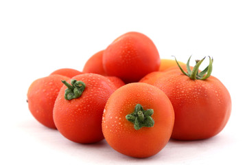 Tomatoes with water droplets on white background