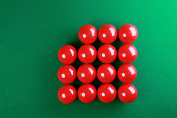 Red snooker balls with square shape on green background